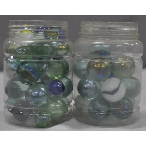 143 - 2 JARS OF GLASS MARBLES