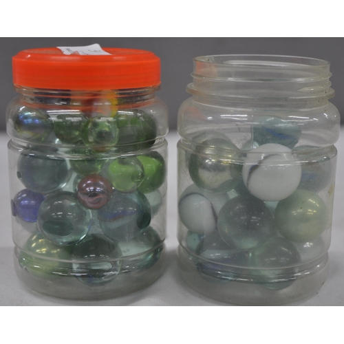 143 - 2 JARS OF GLASS MARBLES
