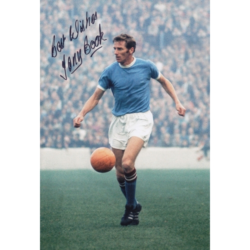 213 - Autographed TONY BOOK 12 x 8 Photograph: Manchester City captain TONY BOOK, with the ball at his fee... 
