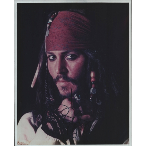 26 - Johnny Depp signed Pirates of the Caribbean 10x8inch colour photo.