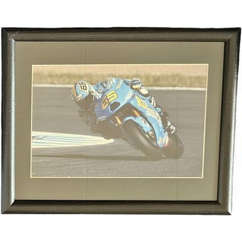 65 - Loris Capirossi 16x12 inch framed and mounted colour photo. Unsigned. Good condition Est.