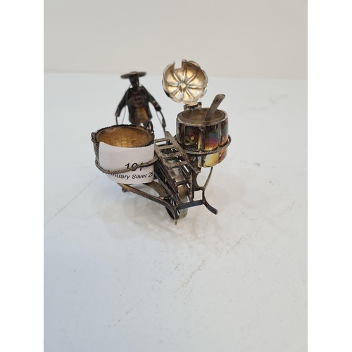 101 - A Chinese silver novelty salt by Hung Chong, of a figure pushing a cart. Condition report: Slight we... 