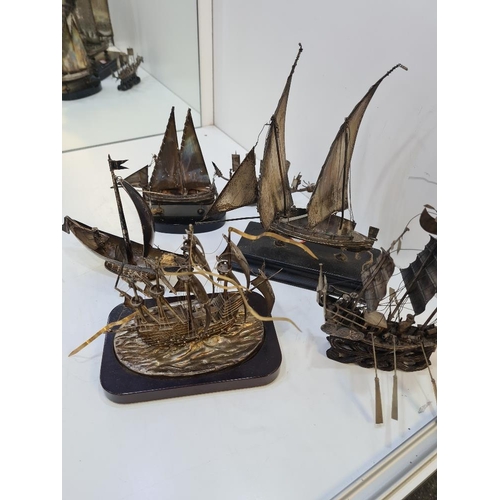 106 - A selection of silver and white metal boats including Chinese and Maltese examples. On wooden stands... 