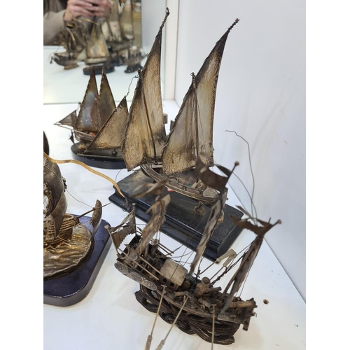 106 - A selection of silver and white metal boats including Chinese and Maltese examples. On wooden stands... 