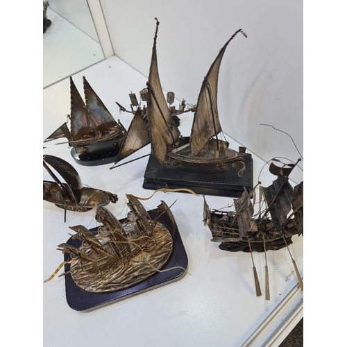 106 - A selection of silver and white metal boats including Chinese and Maltese examples. On wooden stands... 