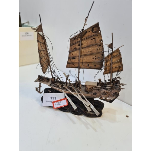 111 - Wang Hing; a silver boat, Hong Kong, with three sails, Cannons on deck and a carved wooden base. Fig... 