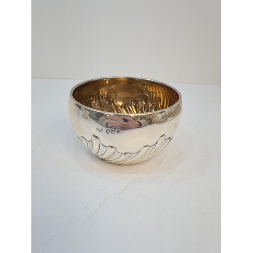 113 - A silver bowl having gilt interior and half gadrooned body. London 1892, makers mark indistinct. 5.0... 