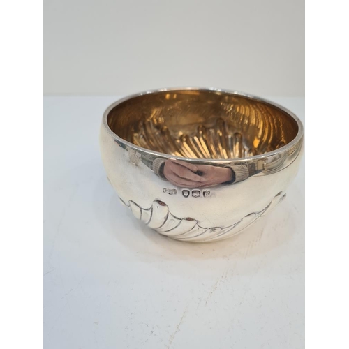 113 - A silver bowl having gilt interior and half gadrooned body. London 1892, makers mark indistinct. 5.0... 