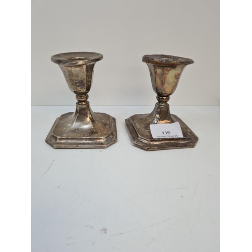 116 - A pair of candlesticks by Mappin and Webb, Birmingham 1921. Octagonal pedestal bases. Condition repo... 