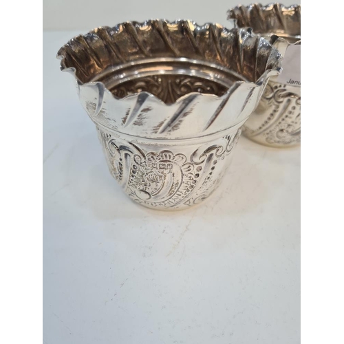 117 - A pair of Victorian silver cups of decorative form, having gadrooned border, embossed and beaded des... 