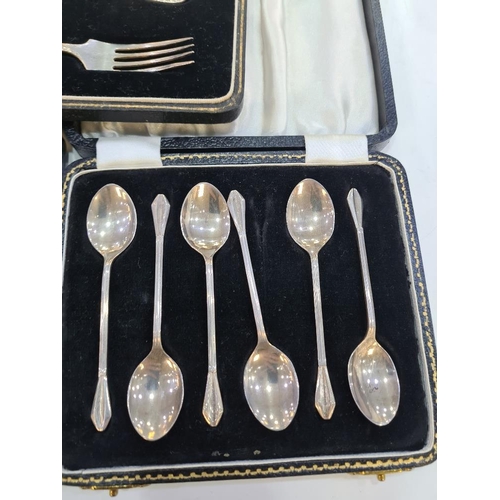 130 - A cased silver christening set of a fork and spoon by William Suckling Ltd. With two cased sets of t... 