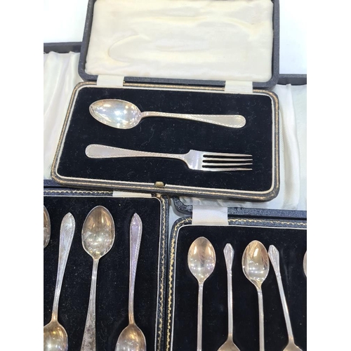 130 - A cased silver christening set of a fork and spoon by William Suckling Ltd. With two cased sets of t... 