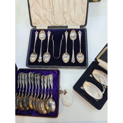 130 - A cased silver christening set of a fork and spoon by William Suckling Ltd. With two cased sets of t... 