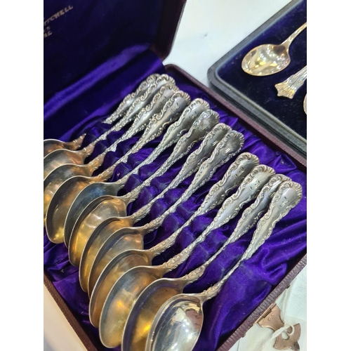 130 - A cased silver christening set of a fork and spoon by William Suckling Ltd. With two cased sets of t... 