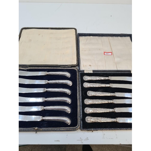 14 - A cased set of silver handled knives by C H Beason, Sheffield 1931, with another cased set by Yates ... 