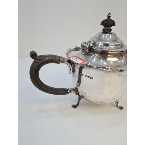 145 - A silver teapot having decorative rim and on three pretty feet, by Mappin and Webb. Hallmarked Sheff... 