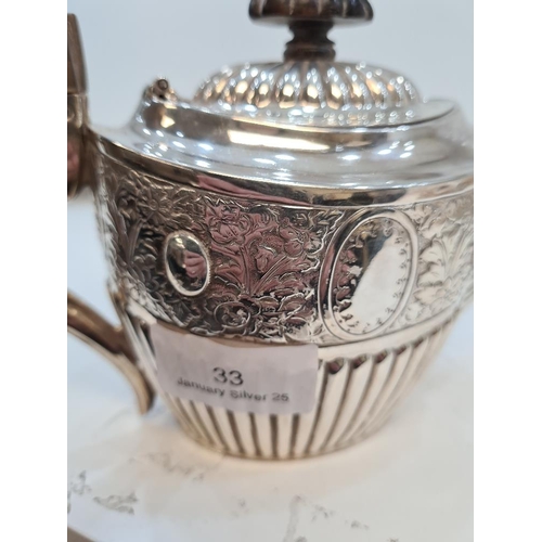 33 - A silver ornate Victorian teapot of pretty form. Hallmarked Birmingham 1894 Barker Brothers. Embosse... 