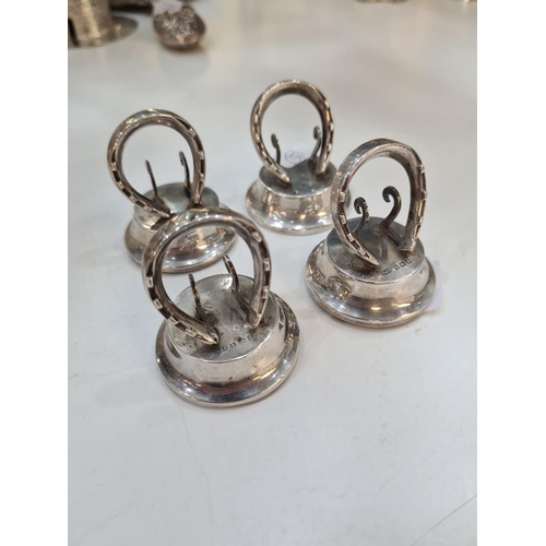 51 - A set of four silver menu holders, of novelty design of horseshoe. Hallmarked Birmingham 1913 Levi a... 