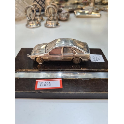 72 - A silver miniature car, on a stand, hall marked London 1983, maker unknown. Condition report: No obv... 