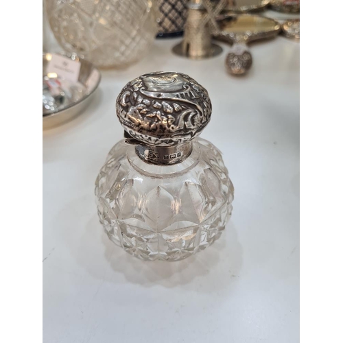 74 - A silver topped scent bottle, body being cut glass and baluster form. Hallmarked Birmingham 1903, Wi... 