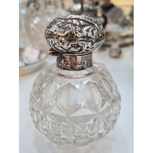 74 - A silver topped scent bottle, body being cut glass and baluster form. Hallmarked Birmingham 1903, Wi... 