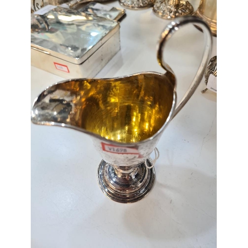 79 - A Victorian silver pretty milk jug with gilt interior, domed circular pedestal foot and engraved fol... 