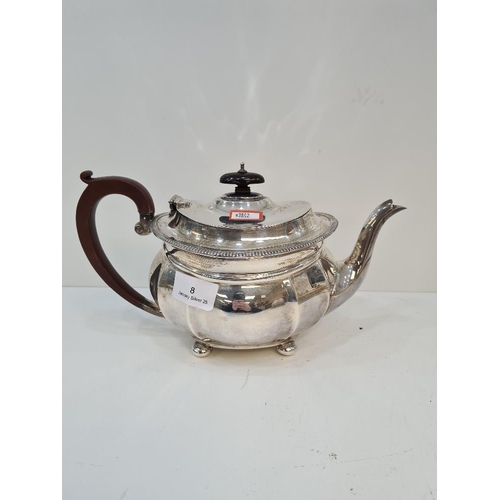 8 - A large silver teapot on four ball feet. Base marked Selfridge and Co Ltd. Gadrooned border and deco... 