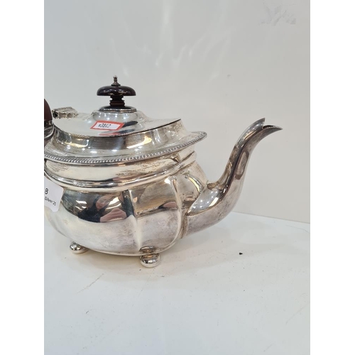 8 - A large silver teapot on four ball feet. Base marked Selfridge and Co Ltd. Gadrooned border and deco... 