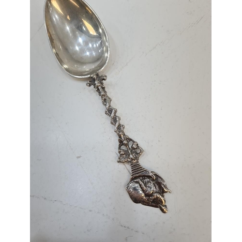 82 - A Dutch spoon having decorative Wrythen handle, pierced detail, and terminating in a design of a fig... 