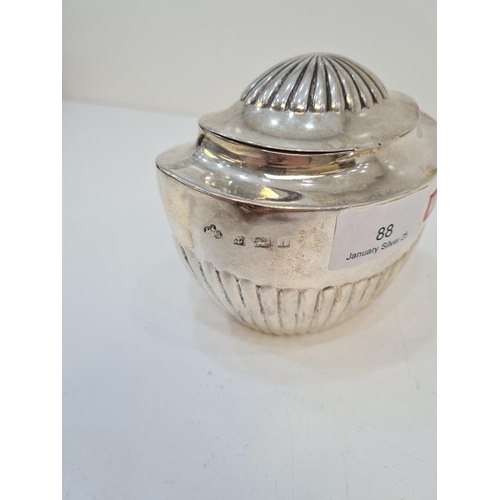 88 - Elkington and Co. A silver tea caddy having half reeded body and top, on a hinged lid. Hallmarked Bi... 