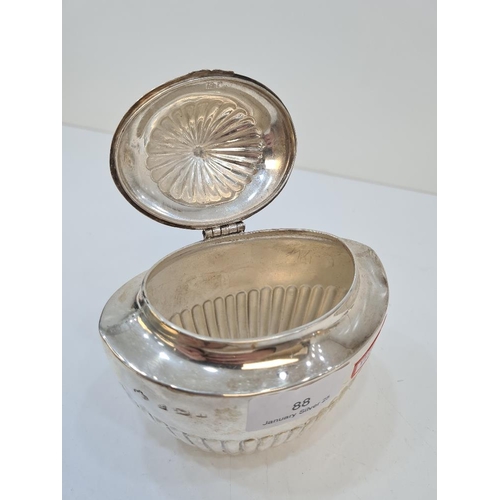 88 - Elkington and Co. A silver tea caddy having half reeded body and top, on a hinged lid. Hallmarked Bi... 