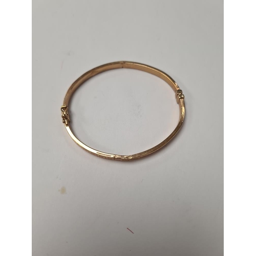 1009 - 9ct yellow gold hinged bangle with Greek key design, dented, marked 375, Birmingham, maker SG, appro... 