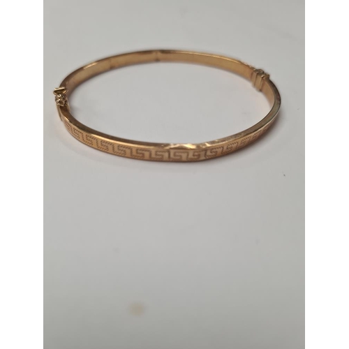 1009 - 9ct yellow gold hinged bangle with Greek key design, dented, marked 375, Birmingham, maker SG, appro... 