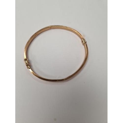 1009 - 9ct yellow gold hinged bangle with Greek key design, dented, marked 375, Birmingham, maker SG, appro... 