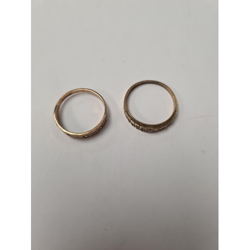 1022 - Two 9ct band rings inset with cubic zirconia stones, both marked 375, sizes O + R, 3.9g approx