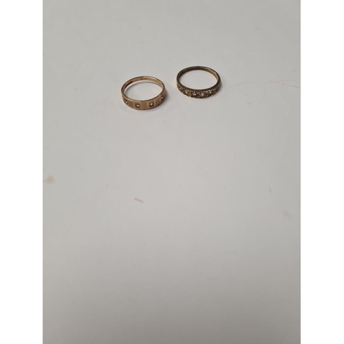 1022 - Two 9ct band rings inset with cubic zirconia stones, both marked 375, sizes O + R, 3.9g approx