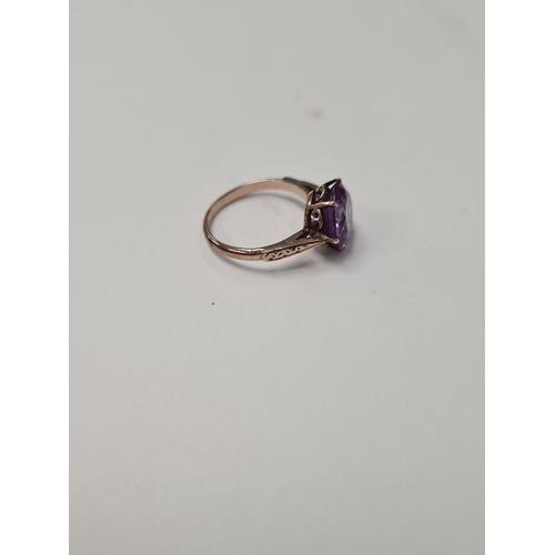 1035 - unmarked rose gold cocktail ring with large round mixed cut amethyst, size I, approx 2.2g