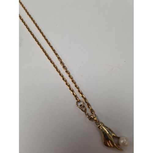 1064 - 9ct yellow gold neckchain, marked hung with a 14ct yellow gold pendant in the form of a hand holding... 