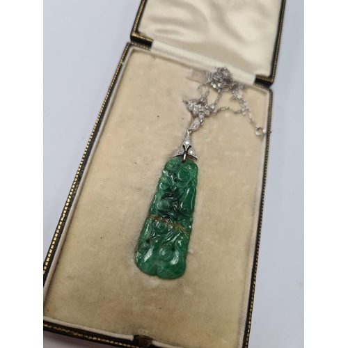 1071 - White metal chain with central diamond inset panel hung with carved jade pendant, AF, repaired, unma... 