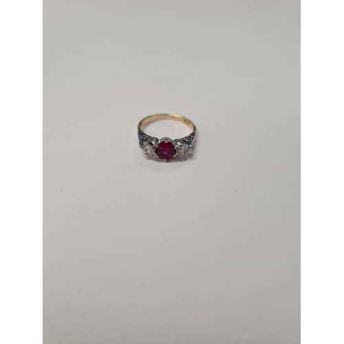 1087 - Mid Century Ruby and Diamond trilogy ring with central oval cut ruby 6.8 mm x 5.5mm, and two old bri... 