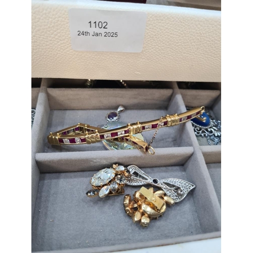 1102 - Jewellery box containing plated bangles, coins, opal brooch etc 