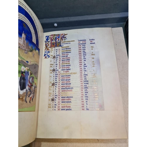 1137 - The Tres Riches Heures of the Duke of Berry red and gilt illuminated book. Leather bound with reader... 