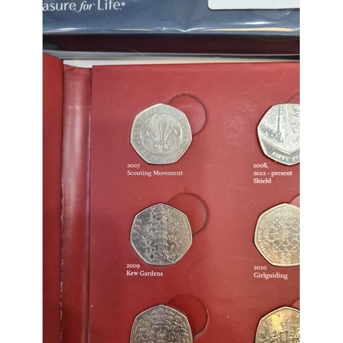 1179 - Collection of 50p coins in cardboard case, majority circulated incl. Kew Gardens, also a sealed set ... 