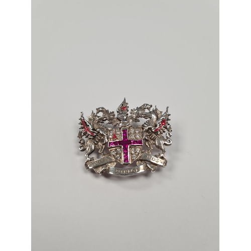 1052 - A silver 'City of London' brooch, central shield set synthetic rubies in a cross and clear stones, f... 