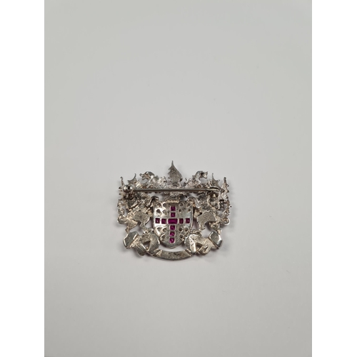 1052 - A silver 'City of London' brooch, central shield set synthetic rubies in a cross and clear stones, f... 