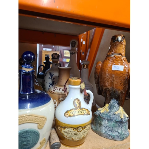 50 - Quantity of Whisky, Rum and other decanters, all empty including a Doulton Golden Eagle