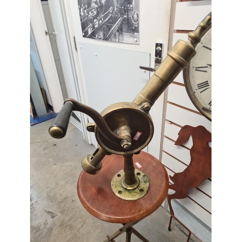 186 - Old brass bar mounted corkscrew, probably early 20th Century