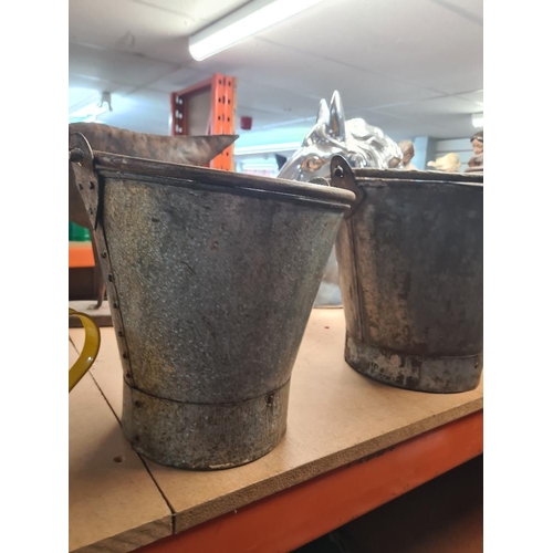 240 - Three metal graduated buckets