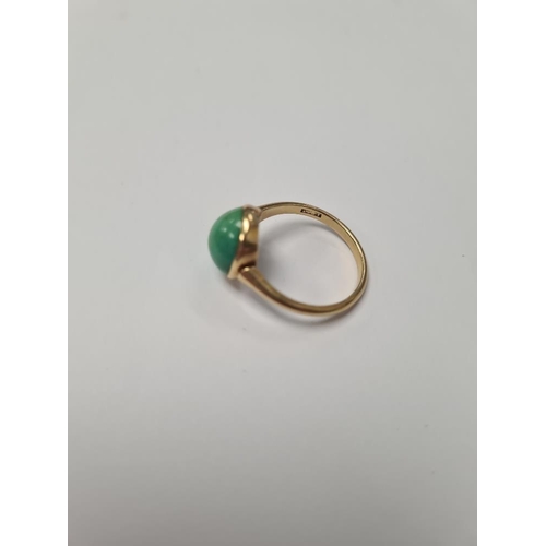 1025 - 18ct yellow gold dress ring, with large cabouchon green hardstone, size Q, marked 18ct, 4.16g approx