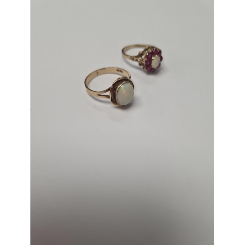 1040 - Pretty 9ct ruby and opal cluster ring with central oval opal surrounded rubies, marked 375, size O, ... 